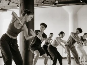 erformers dancing in the studio space at MAE Dance, highlighting the open layout and flooring installed by GCM Construction.