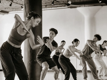 erformers dancing in the studio space at MAE Dance, highlighting the open layout and flooring installed by GCM Construction.