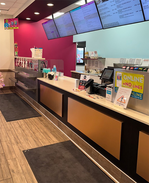 Interior of the Planet Smoothie and Great Steak location, showcasing a clean, modern service counter, menu displays, and a bright, functional food preparation area.