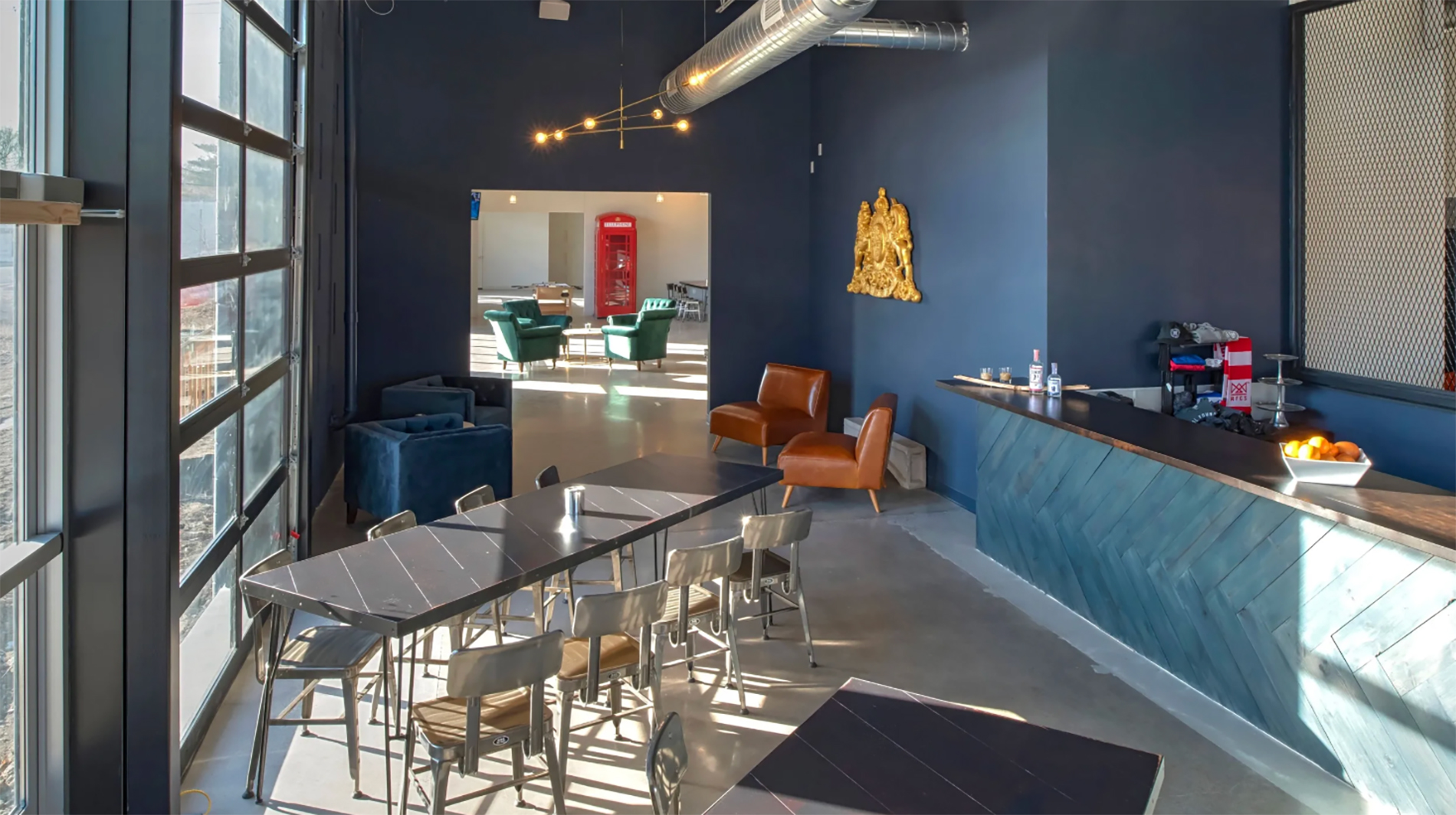 GCM Construction office interior featuring modern blue walls, comfortable lounge seating, and contemporary lighting.