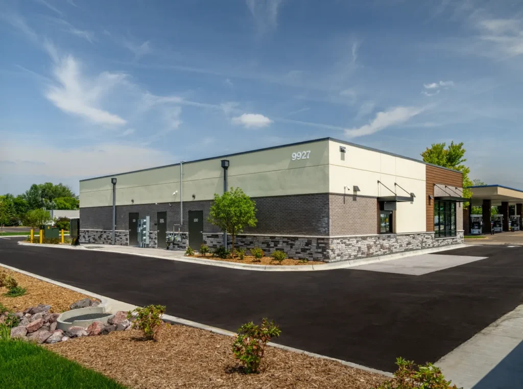 Exterior of a new commercial building featuring modern metal siding and large windows, representing a successful tenant buildout by GCM Construction.